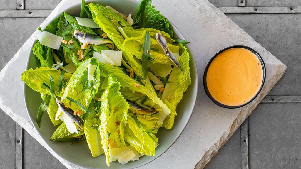 Whole Leaf Caesar Salad · Romaine Hearts, Creamy Caesar Dressing, Grilled Croutons, Boquerones, Parmesan, Fresh Herb Salad. Dressing served on the side.