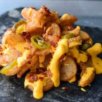 Loaded Sidewinders · Twisty fries with tasty Rocketbird malty seasoning, Rocketbird Queso, crumbled bacon, and ja...