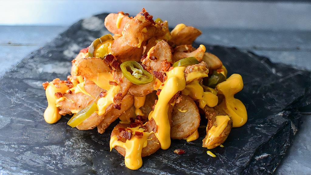Loaded Sidewinders · Twisty fries with tasty Rocketbird malty seasoning, Rocketbird Queso, crumbled bacon, and jalapenos.
