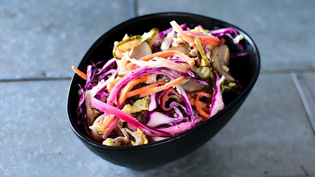 Rocketbird Slaw (VE/DF/GF) · Vegan, dairy-free, gluten-free and delicious! 4 oz serving size. Cabbage, house-pickled vegetables (carrots, red onions, mustard seeds, jalapenos, apple cider vinegar), and house made creamy celery seed dressing.