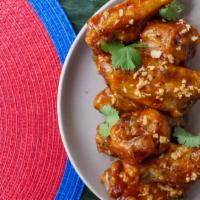 TOCINO WINGS · House-cured house tocino glaze with fried garlic and cilantro