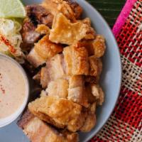 LECHON KAWALI · Crispy chopped pork belly with ginger, garlic. Served with Uncle Tito Sauce, citrus, and a s...