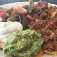 Azteca Nachos · Fresh corn tortilla chips topped with ground beef, refried beans, melted monterey jack, ched...