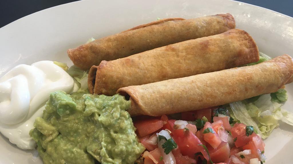 Taquitos · Three corn tortillas rolled and filled with shredded beef or chicken, fried and sawed with our homemade guacamole, sour cream and pico de gallo.