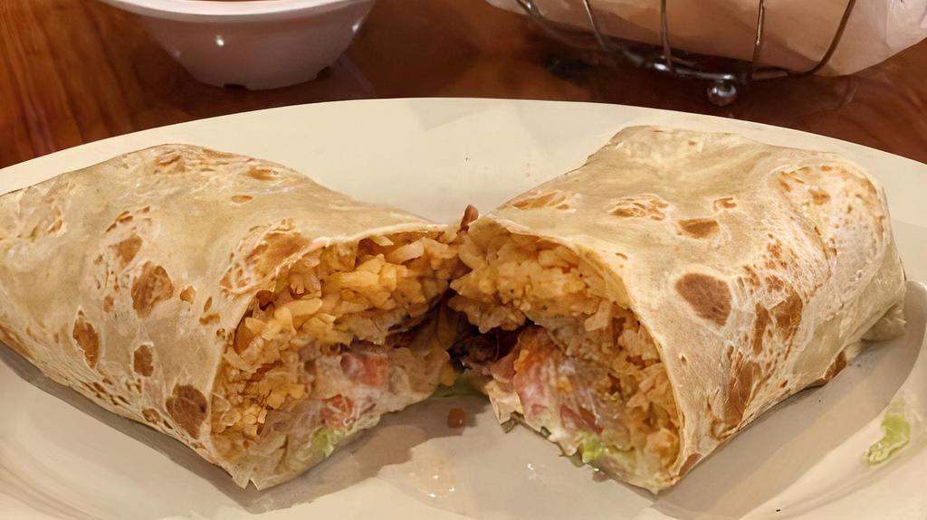Super Burrito · Flour tortilla filled with refried beans, rice, lettuce, cheese, sour cream, and tomato. Protein choice of ground beef, shredded beef, pork chile verde, carne asada, carnitas, chicken, and shrimp.