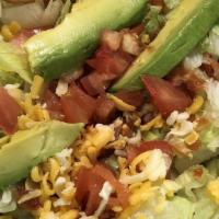 Fiesta Salad · Flour tortilla bowl filled with lettuce, choice of ground beef, shredded beef, or chicken to...