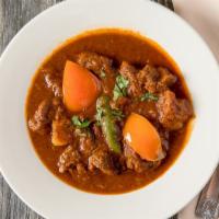 21. Lamb Vindaloo · Spicy. Lamb cooked with spicy sauce and potatoes.