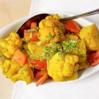 Aloo Gobi · Vegan, gluten-free. Cauliflower and potatoes, sautéed with fresh tomatoes, ginger, green chi...