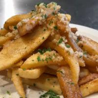 Stinky Fries · Our steak cut fries are tossed in our house made garlic sauce, then topped with grated parm.