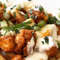 Buffalo Chicken Poutine · Our Classic poutine with the addition of fried chicken tenders in buffalo sauce, with blue c...