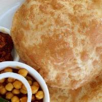 Chole bhature · Puffed leavened bread and chana masala.