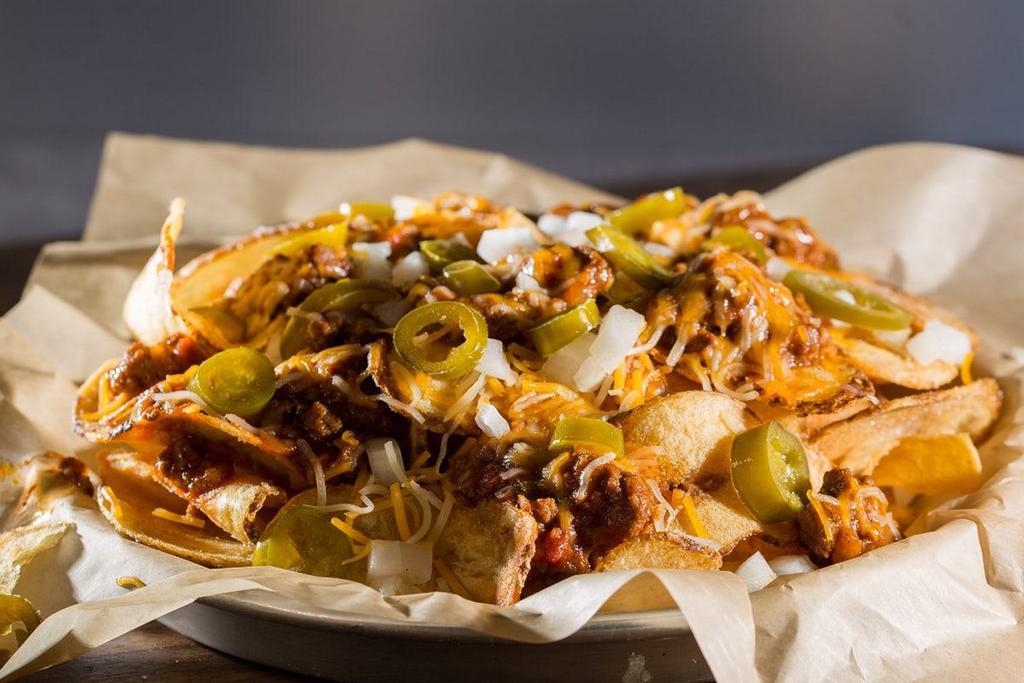 Irish Nachos · If you want to try the chips but need a little something extra, look no further. Our house-made chips topped with chili, jalapenos, onions, and Cheddar Jack cheese.