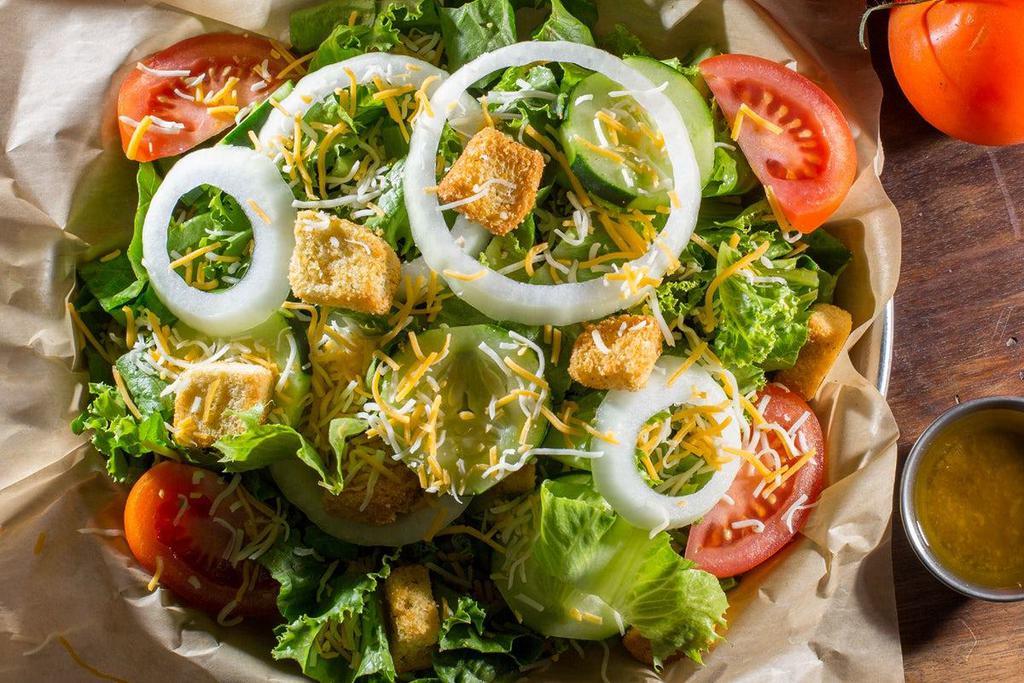 Garden Salad · A traditional but tasty salad that perfectly hits the spot. Crisp green leaf lettuce, tomato, cucumbers, onions, croutons, and Cheddar Jack cheese. Topped with balsamic vinaigrette dressing.