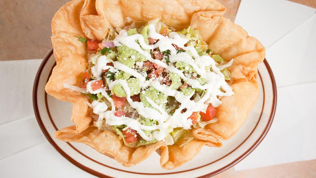 Taco Salad · Served with your choice of meat, rice, whole beans cheese, lettuce, sour cream, pico de gallo and guacamole