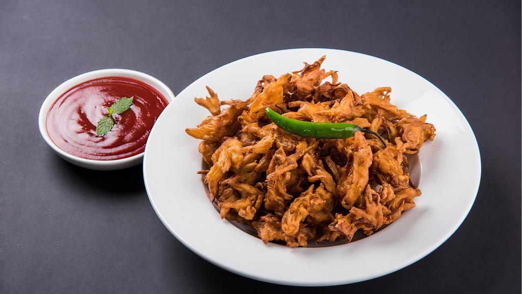 Veg Pakora · Deep-friend Crispy Snack made with Spinach Onions and Carrots.