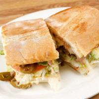 Torta · French roll, choice of meat, re-fried beans, cheese, sour cream, tomato, lettuce, avocado an...