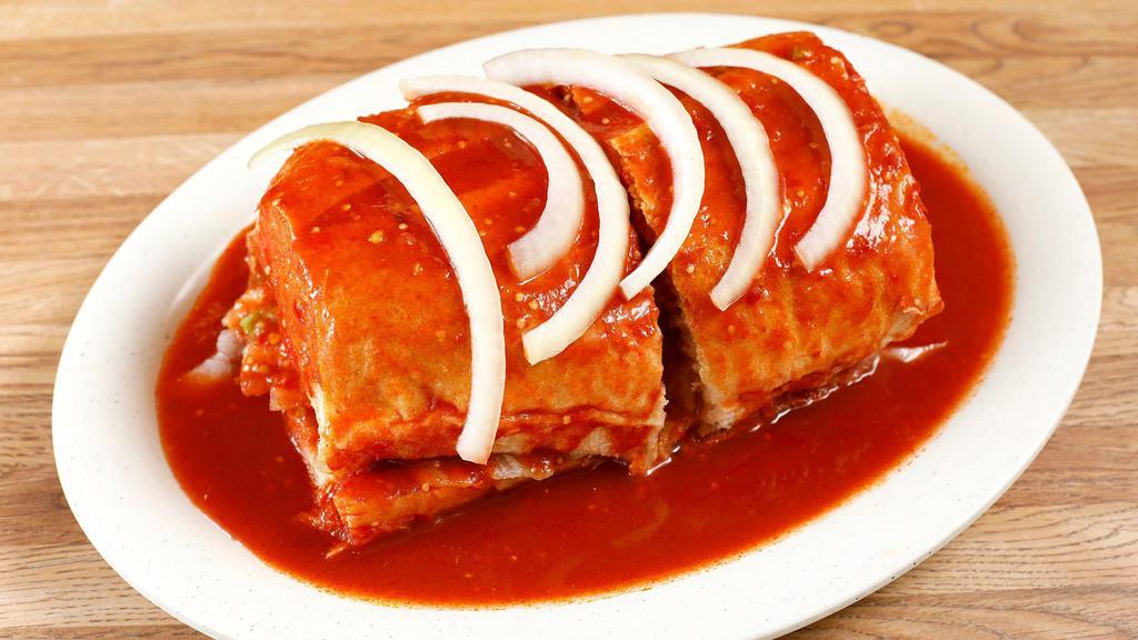Torta Ahogada · French roll, choice of meat, beans, cheese, sour cream, and jalapenos topped off with red Chile pasilla sauce.