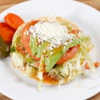 Tostada · Corn fried tortilla topped with choice of meat, choice of beans, lettuce, tomatoe, sour crea...