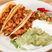 Tacos Dorados · 3 crispy tacos, choice of meat, topped with lettuce, cheese, tomatillo salsa.