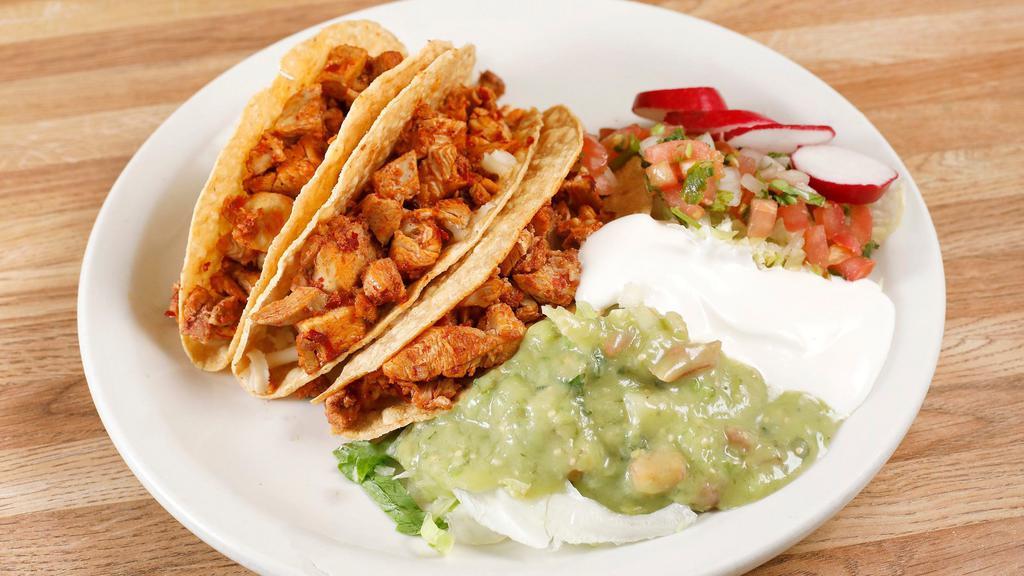 Tacos Dorados · 3 crispy tacos, choice of meat, topped with lettuce, cheese, tomatillo salsa.