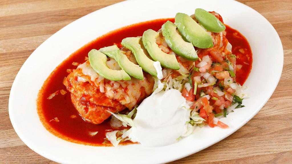 Burrito Mojado · choice of Meat, beans, Rice, Cheese, topped with Red Salsa, Melted Cheese, Sour Cream and Guacamole