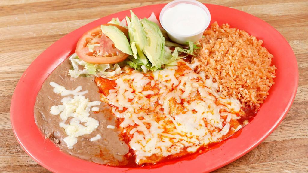 Enchiladas · 3 enchiladas stuffed with choice of meat, topped with melted cheese and red enchilada sauce.