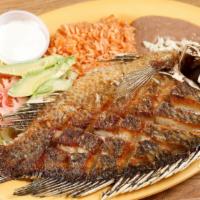 Mojarra · An entire whole deep fried tilapia with your choice of beans, rice or fries and salad.