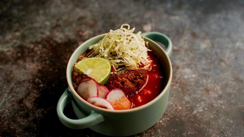 Pozole Rojo (lg) · pork shoulder, hominy, ancho & guajillo chile, cabbage, red onion, radish, lime, oregano, salsa macha.