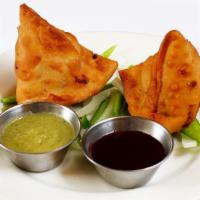 Samosas · Two pieces. Deep fried pastry shells, stuffed with potatoes and peas.