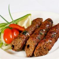 Lamb Seekh Kebab · Two pieces. Ground lamb marinated in spices on skewers and cooked in clay oven.