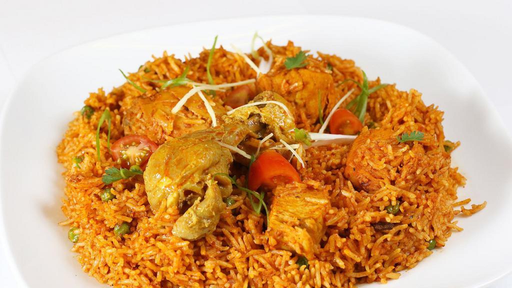Goat Biryani · Goat on bone cooked with basmati rice  and spices .