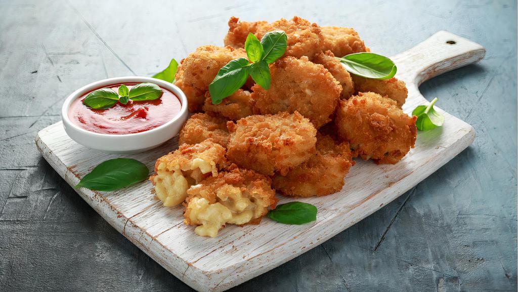 Mac and Cheese Bites · Basket of Mac n Cheese bites served with sauce.