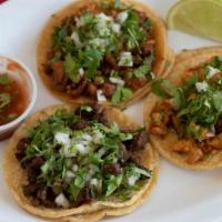 Regular Taco · Choice of meat, onion, cilantro and salsa served on a corn tortilla.