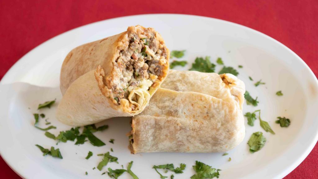 Super Burrito · Choice of meat, rice, beans, onion, cilantro, cheese, sour cream, guacamole and salsa.