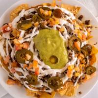 Nachos With Meat · Tortilla chips layered with your choice of meat, beans, cheese, sour cream, tomatoes, jalape...