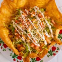 Taco Salad · Fried tortilla shell stuffed with choice of meat, rice, lettuce, cheese, diced tomatoes, sou...