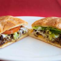 Torta · Choice of meat served with mayo, tomatoes, onion, lettuce, cheese, sour cream and guacamole.