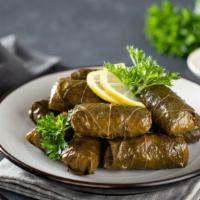 6pc Dolma · Grape leaves stuffed with rice.