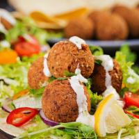 Falafel Salad · 5PC falafels, roman heart, cucumber, tomatoes, and creamy tahini dressing, & Yogurt Sauce