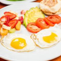 Two Eggs Any Style with Avocado and Tomato · Served with English muffin and choice of fruit or hash browns.