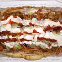 Lamb Gyro · Juicy grilled lamb gyro wrapped in a pita bread topped with onions, tomatoes, lettuce and tz...