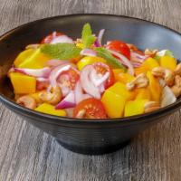 Mango Salad · Sweet mango tossed in a home made dressing , red onions, cherry tomatoes & cashew nuts.