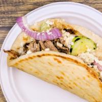 Chicken Souvlaki (in Pita) · Marinated chicken in a warm pita with tzatziki, bell peppers, grilled onions & tomatoes.
