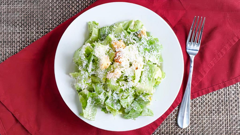 Caesar Salad · Romaine lettuce, homemade croutons, caesar dressing and shaved parmesan cheese.