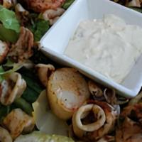 Grilled Seafood Salad · Prawns, Scallops & Calamari marinated in pesto and grilled. Over lettuce with sides of Itali...