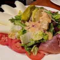 Antipasto Misto · Salad with sliced mozzarella, tomatoes, artichoke hearts, pepperoncini, kalamata olives, sal...