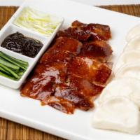 CR9. Imperial Peking Duck · Marinated duck roasted to a crispy skin served with steamed buns, scallion, and hoisin sauce.