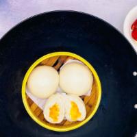 ST2. Steamed Salted Egg Yolk Bun (3) · Flour bun filled with leaking lava egg yolk that is sweet and salty in flavor.