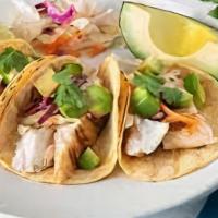 Grilled Fish Tacos · Grilled white fish, corn tortillas, Sriracha crema, shredded cabbage and red onions and cila...