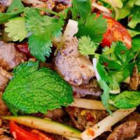Grilled Beef Salad · Medium spicy. Green apples, mint leaves, tomatoes, red onions, cilantro, roasted rice, and c...